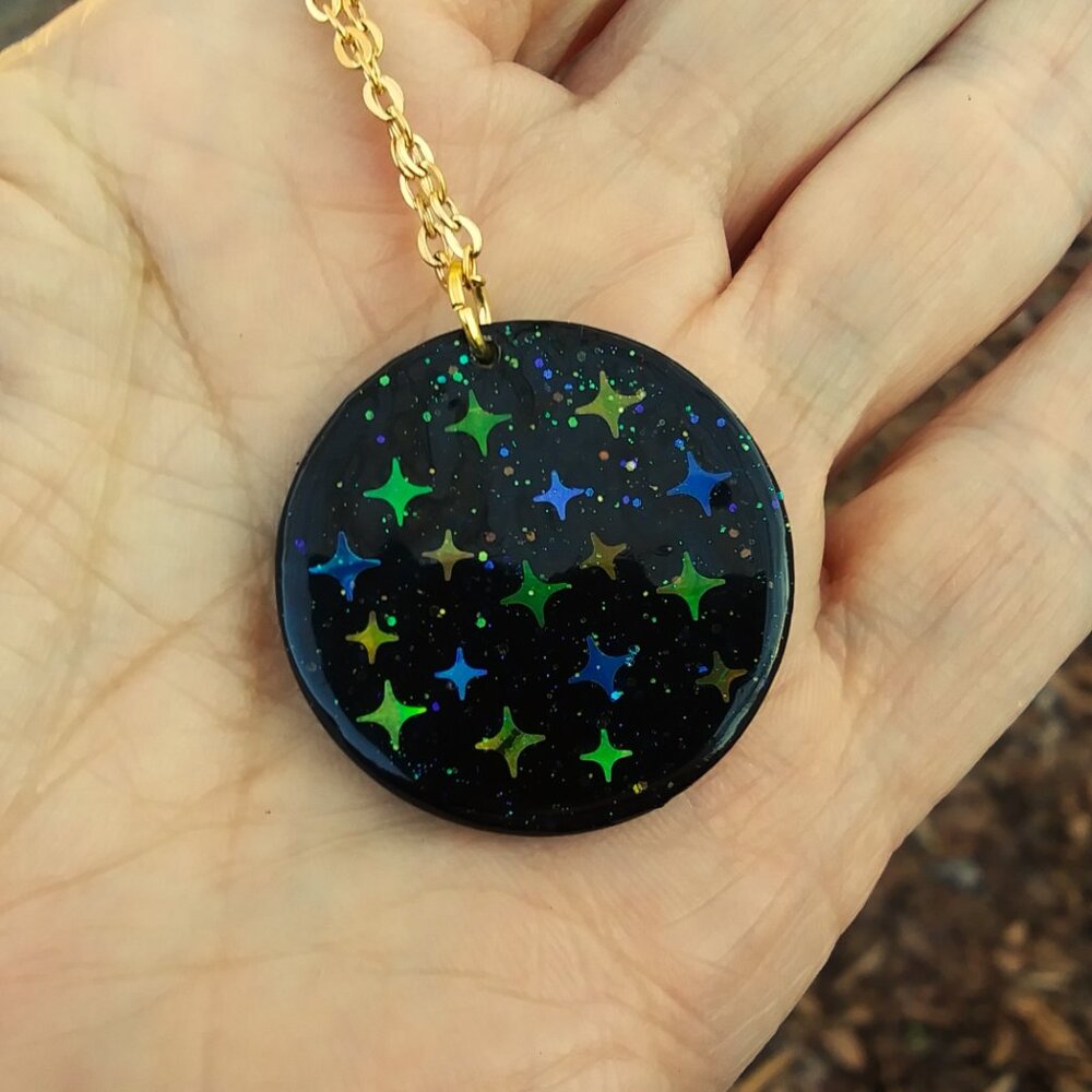 Black and multi colored northern star disc gold tone necklace